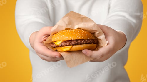 Preview: Big Tasty Cheeseburger In Hands Of Unrecognizable Plus Size Woman
