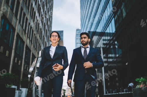 Preview: Business colleagues walking in street in downtown