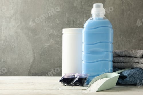 Preview: Laundry accessories on white wooden table against gray background
