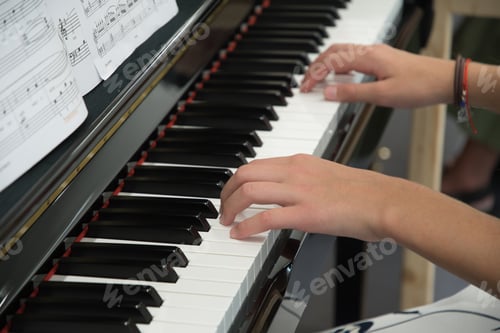 Preview: teenage girl playing the piano in the classroom, music hobby