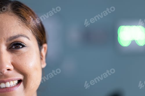 Preview: Unaltered portrait of happy asian female doctor smiling in hospital corridor, with copy space
