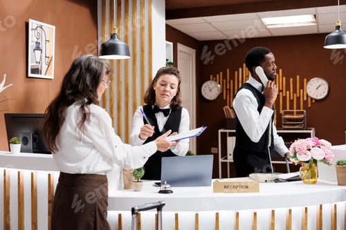Preview: Elderly woman signs hotel paperwork
