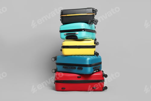 Preview: Stack of colorful suitcases on grey background
