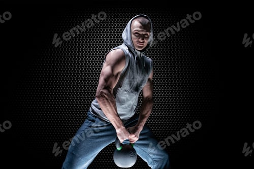 Preview: Portrait Of An Athlete Crouching With A Kettlebell. The Concept Of Sport And Healthy Lifestyle