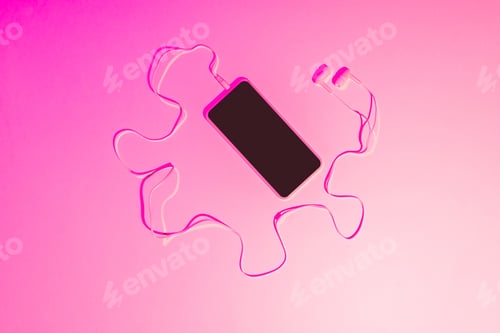 Preview: pink toned picture of smartphone with earphones on pink background