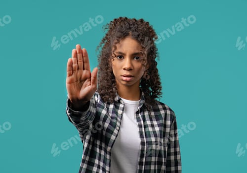 Preview: Uninterested african woman disapproving with NO sign gesture. Denying, rejecting