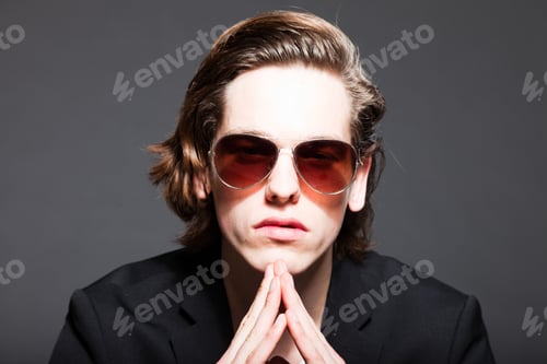 Preview: Handsome Young Man With Brown Long Hair And Wearing White Shirt And Blue Jacket And Sunglasses