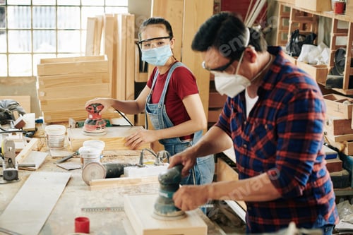 Preview: Carpenters polishing wooden drawers