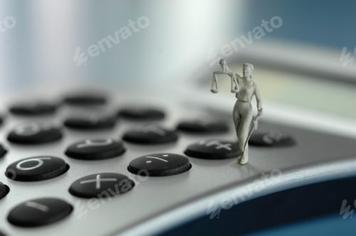 Preview: Justitia figurine on calculator, close up