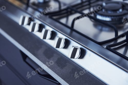 Preview: Close up view of top of a gas stove indoors near wall at daytime