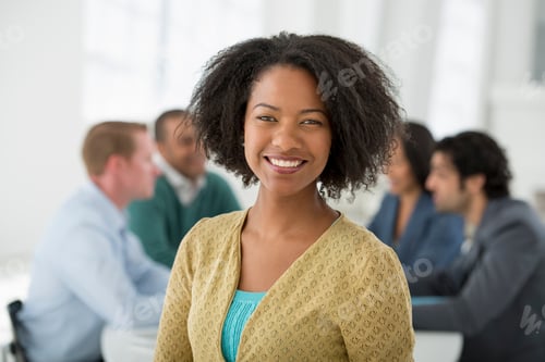 Preview: A group in a business meetings. A business woman in the foreground.