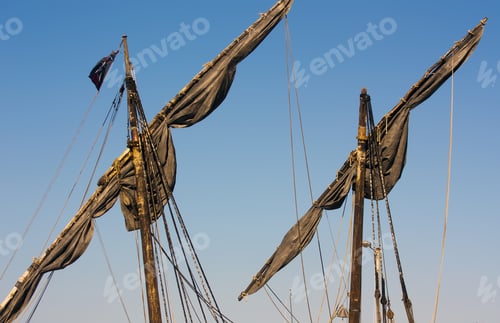 Preview: Dark masts of a ship with the sky in the background