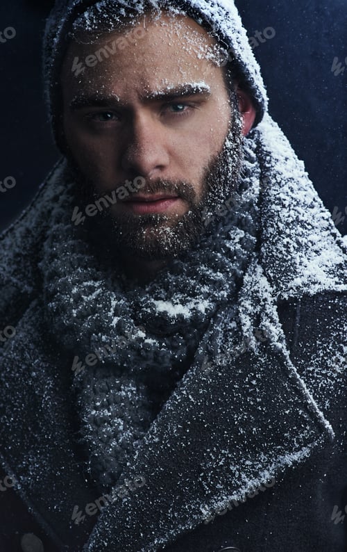 Preview: Smouldering snow. Cropped shot of a handsome young man covered in snow.