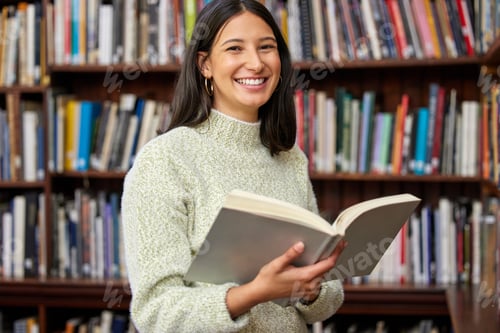 Preview: Success has already been written. Shot of a young woman reading a book in a library.