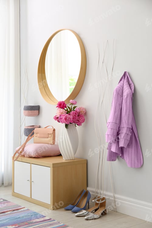 Preview: Stylish hallway interior with round mirror on white wall