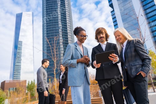 Preview: Multi-ethnic business colleagues or executives, looking at technologies, business park exterior