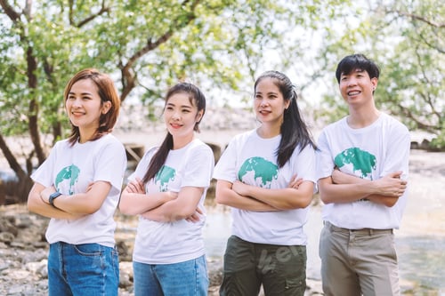 Preview: Group of Asian diverse people volunteer teamwork joining to success the goal on charity event.