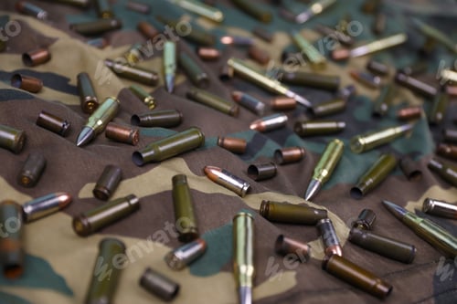 Preview: Many rifle bullets and cartridges on dark camouflage background