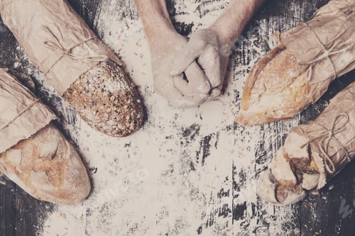 Preview: Bakery concept background. Hands and sorts of bread loaf