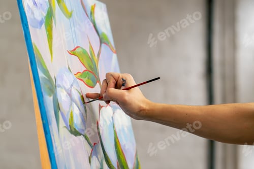 Preview: an art studio a painting with flowers the artist sitting the details on the painting with red paint