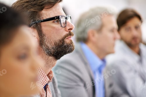 Preview: Project debriefing. Shot of a group of dedicated business professionals sitting in a row.