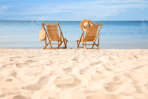 Preview: Wooden deck chairs on sandy beach near sea