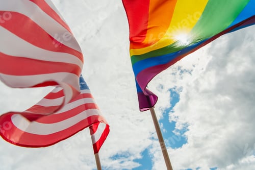 Preview: bottom view of american and colorful lgbt flags against sky with clouds