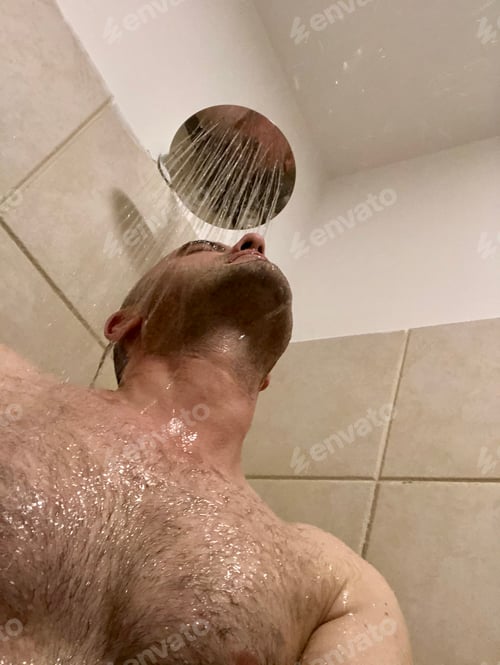 Man Enjoying Refreshing Shower Under Running Water
