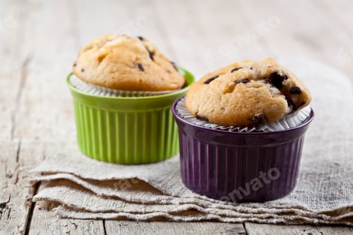 Preview: Delicious Chocolate Chip Muffins Displayed on Wooden Table