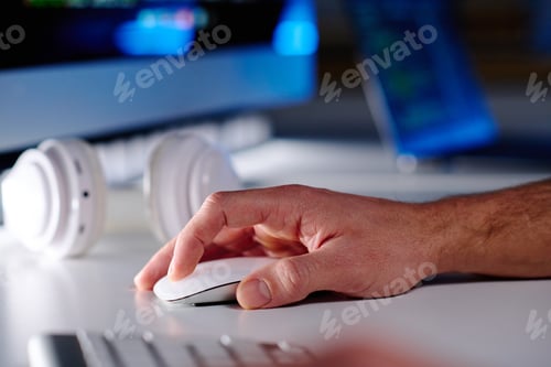 Preview: Hand of mature male IT manager clicking mouse while sitting in front of computer