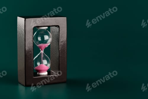 Preview: Sand hourglass on dark green paper background