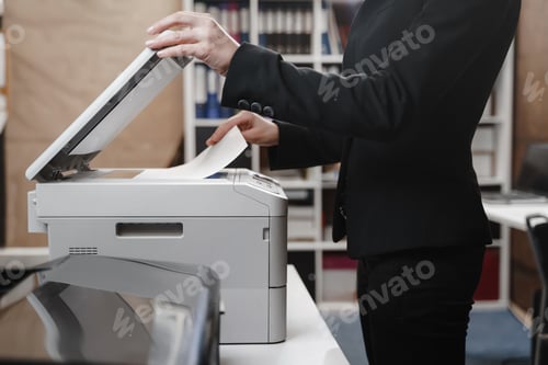 Preview: Business woman is using the printer to scanning