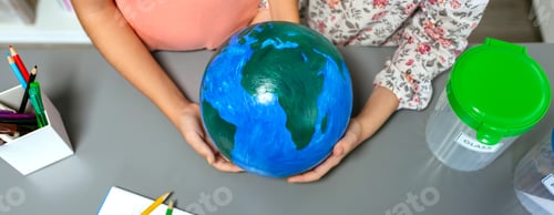 Preview: Two unrecognizable female students holding handmade globe world earth