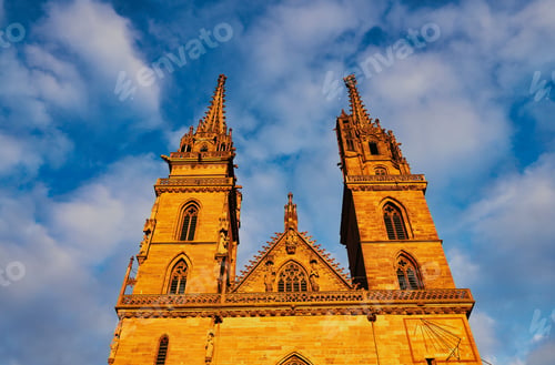 Preview: Low-angle shot of architectural detail of the protestant cathedral of Basel against a blue sky
