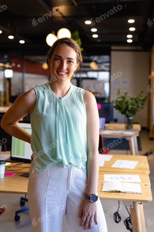Preview: Portrait of happy caucasian casual businesswoman in office