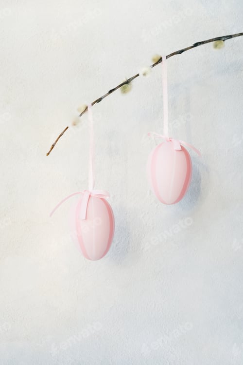 Preview: Easter background. Decorative pink Easter eggs and willow branch on concrete background