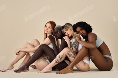 Preview: Diverse multicultural girls wearing underwear sitting on beige background.