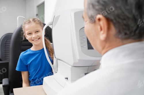 Preview: Patient testing eyesight with eye test machine in clinic