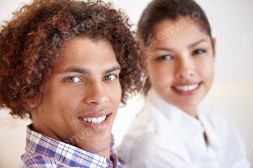 Preview: Quality together. Shot of a young ethnic couple smiling while sitting together in their home.