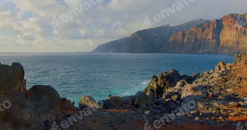 Preview: Amazing ocean view of Los Gigantes cliffs and rocky volcanic beach at sunset, Tenerife, Canary