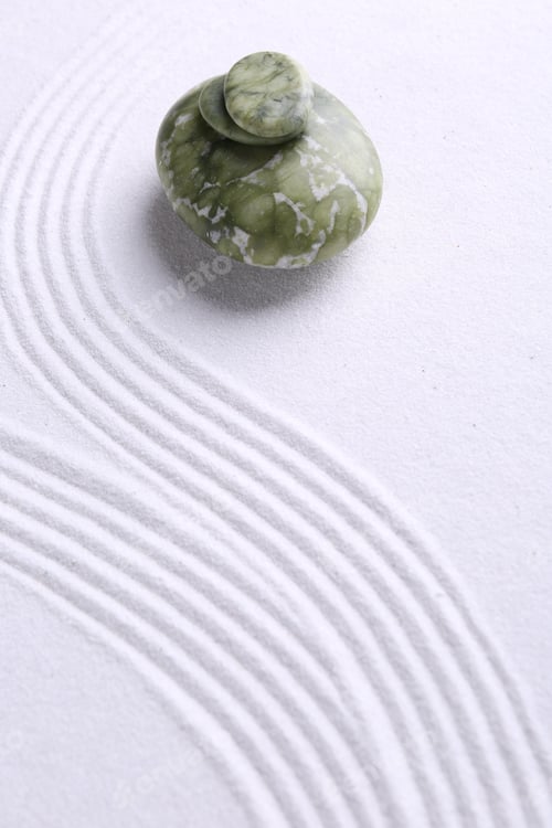 Preview: Zen garden stones on white sand with pattern. Space for text