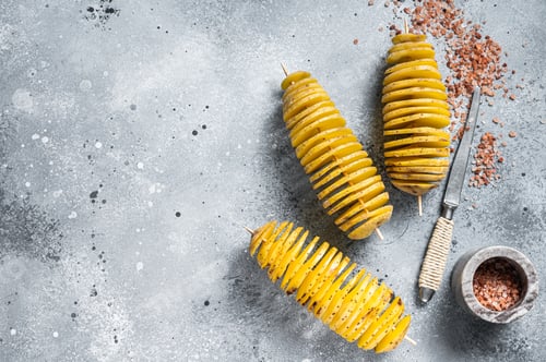 Preview: Cooking Tornado or Twist potato fries. Gray background. Top view. Copy space