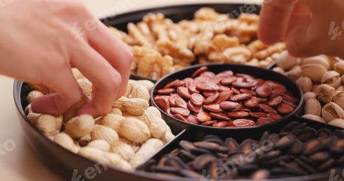 Preview: Hand taking snack from chinese snack tray box