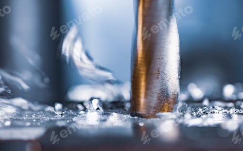 Preview: Drilling process with shavings close-up at the workplace in workshop