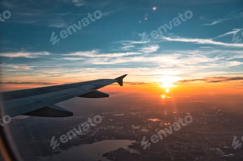 Preview: Mesmerizing view from the plane of the plane wing, the blue cloudy sky at sunset, sun, sundown