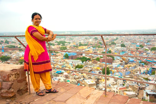 Preview: Portrait of Indian woman against view of Jodhpur the blue city in Rajasthan India