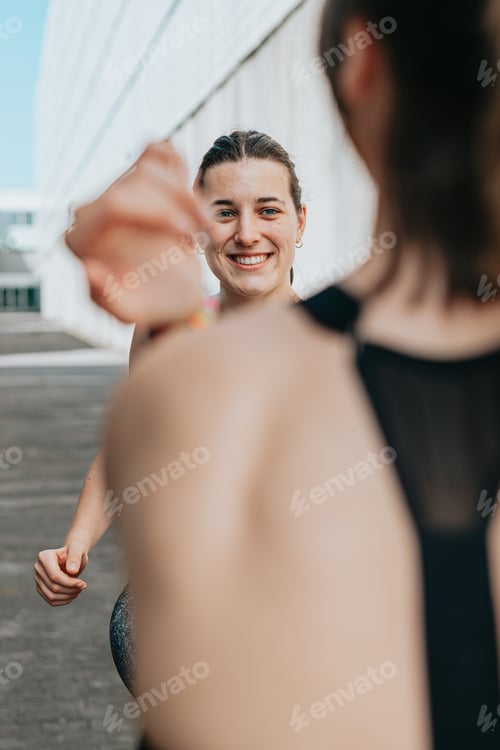 Preview: Young woman trainer teaching the different exercises to a student while they exercise with a smile.