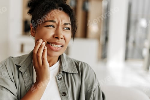 Preview: Young woman suffering from strong toothache at home