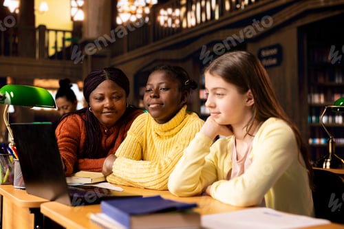 Preview: Two diverse children working with a tutor completing class notes