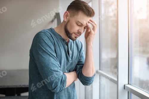 Preview: Man suffering from headache at home